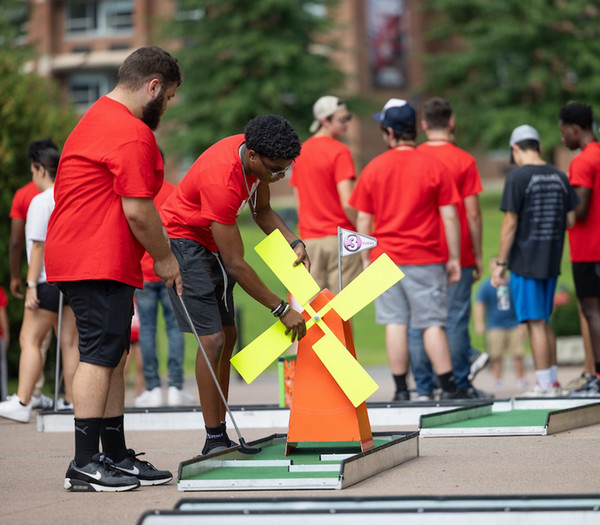 students playing mini golf