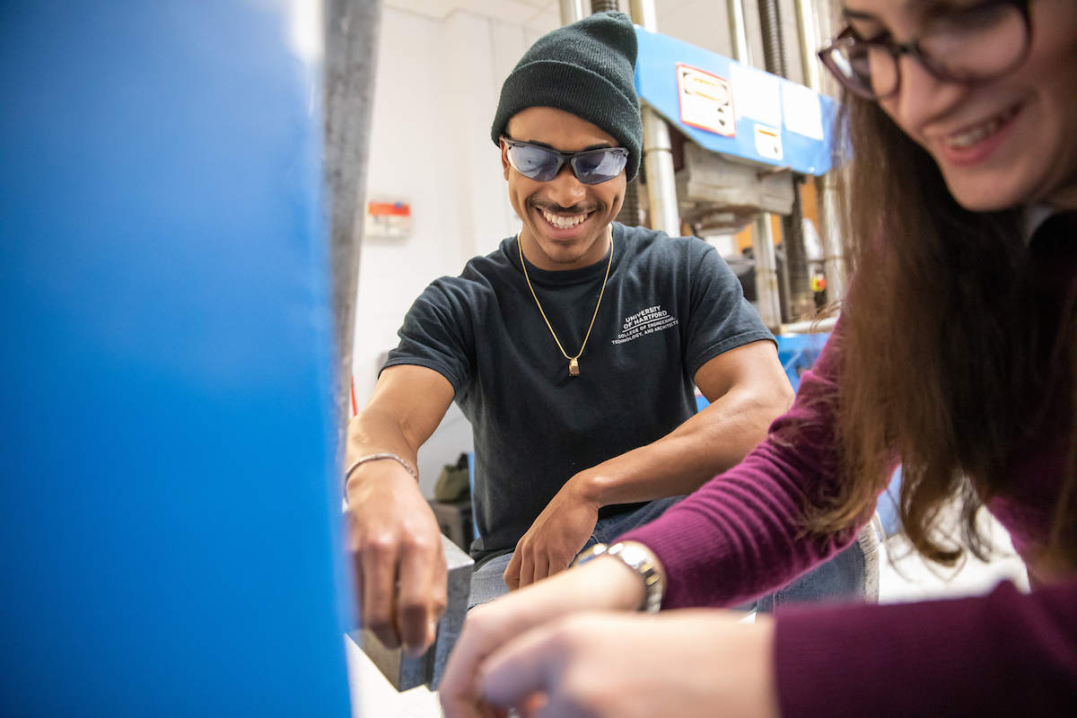 Image is of a student working with a teacher.