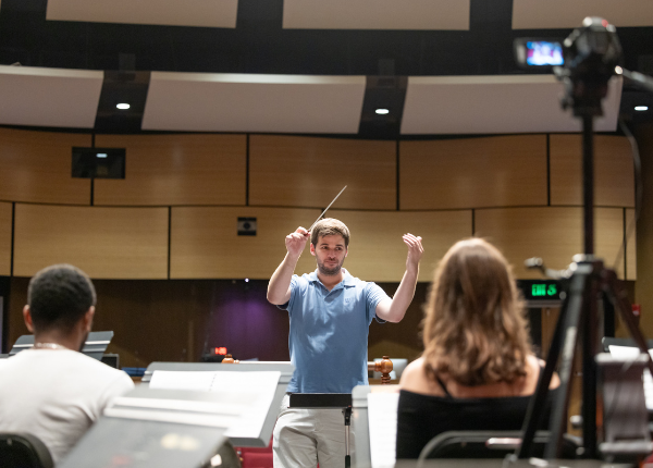 An orchestra professor conducting a student orchestra at the University of Hartford.