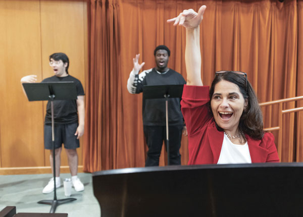 Hartt School professor, Carolina Flores, conducts two students singing.