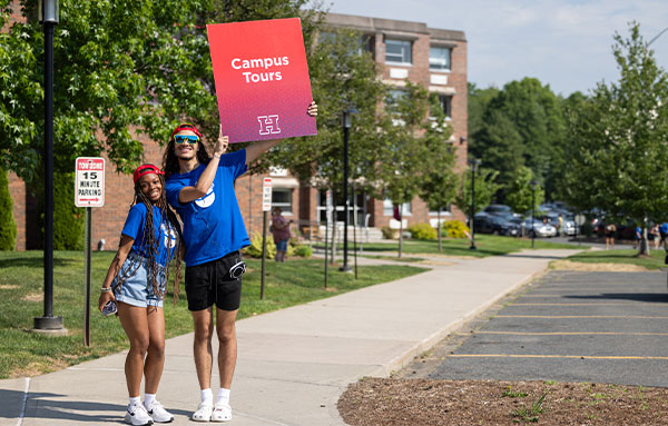 Students with campus tour sign