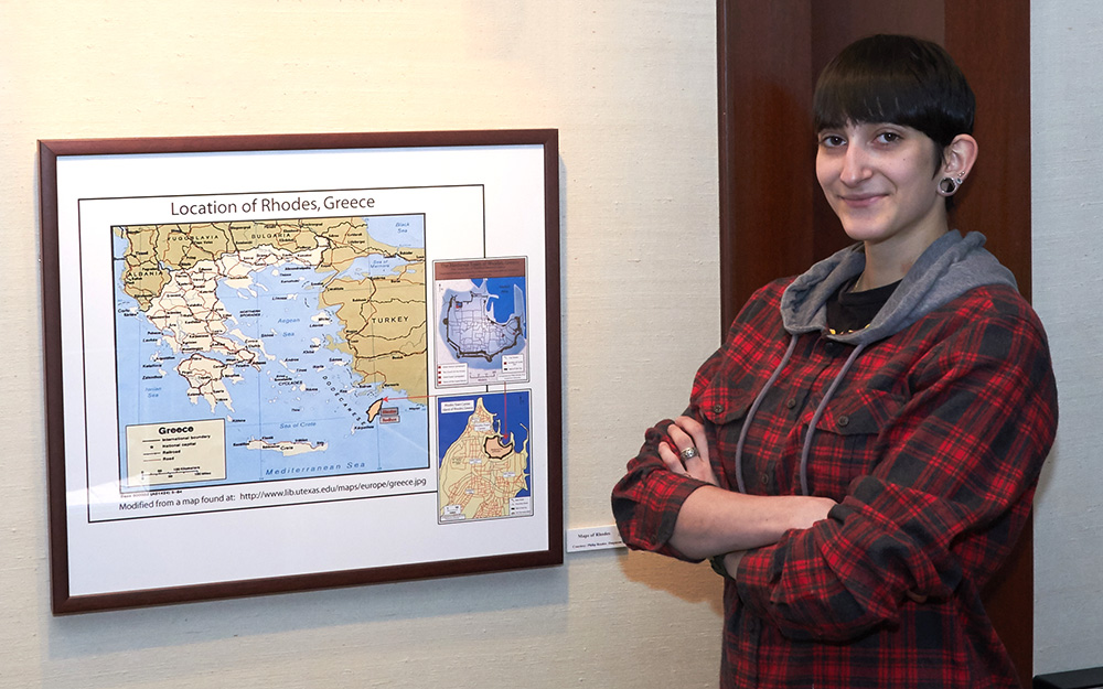 Nicole Awad in the The Museum of Jewish Civilization, by a map of where she and a team of researchers used ground-penetrating radar (GPR) to discover the remains of a synagogue.