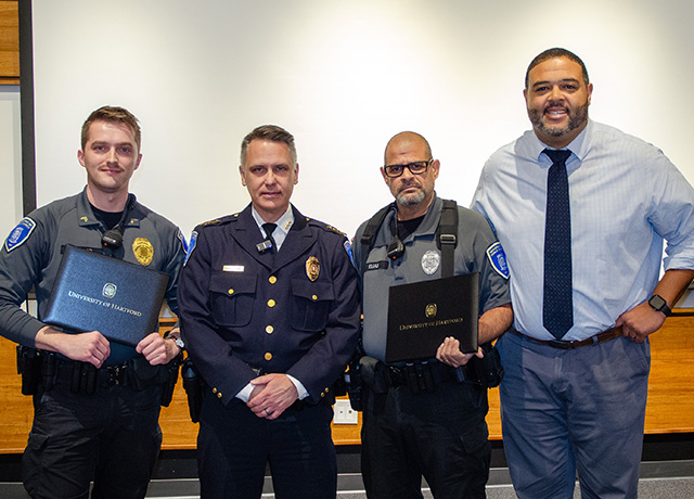 Corporal Matthew Vieweg and Officer Armando Elias with Public Safety Chief Michael Kaselouskas and Dean of Students Aaron Isaacs