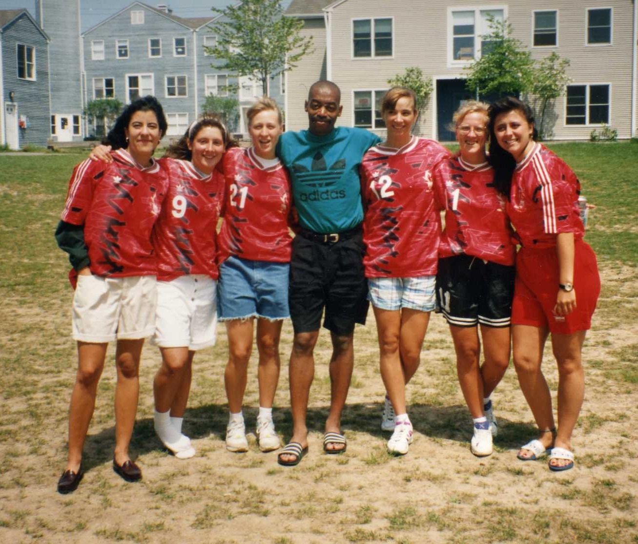 Coach Austin Daniels surrounded by members of the University of Hartford women's soccer team